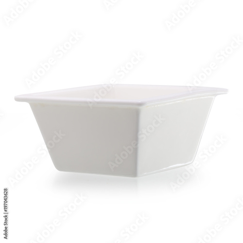 Small glazed ceramic ramekin isolated on white.