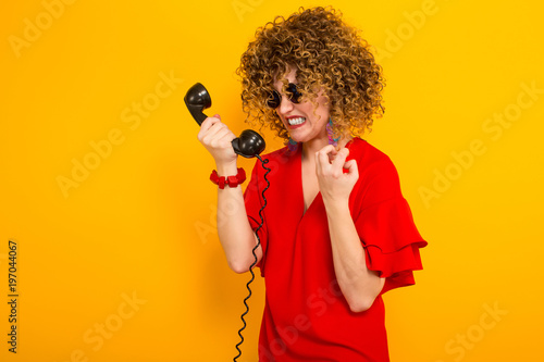 Attractive woman with short curly hair with phone
