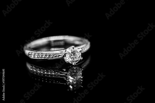 Close up Jewelry diamond ring on black background with reflection