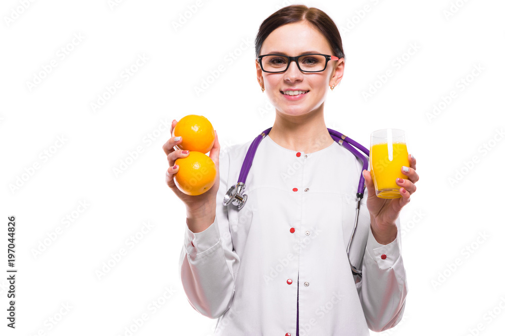Female nutritionist hold oranges and glass of fresh juice in her hands on white background Female nutritionist hold oranges and glass of fresh juice in her hands on white background