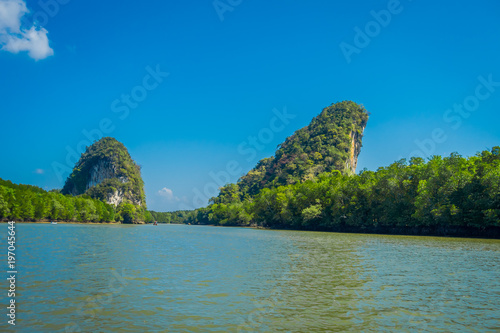 Beautiful outdoor view of huge mountains in the horizont, viewed from the river during a gorgeopus blue asky in Krabi Province, South of Thailand