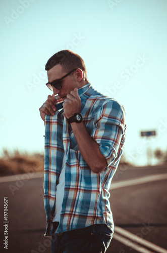 man in spriped shirt walk on the road  (desert) photo