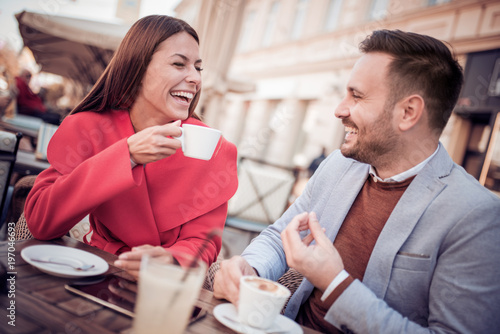 Portrait of happy couple dating at coffee shop