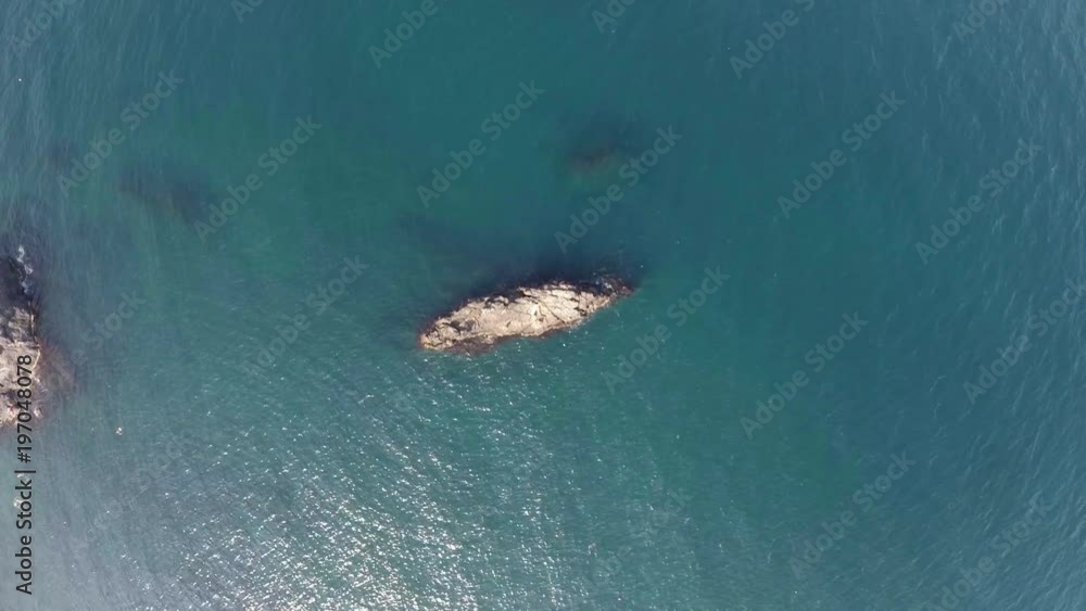 The camera looks at a stone in the sea and fall slowly. The camera looks at a stone in the sea and fall slowly.