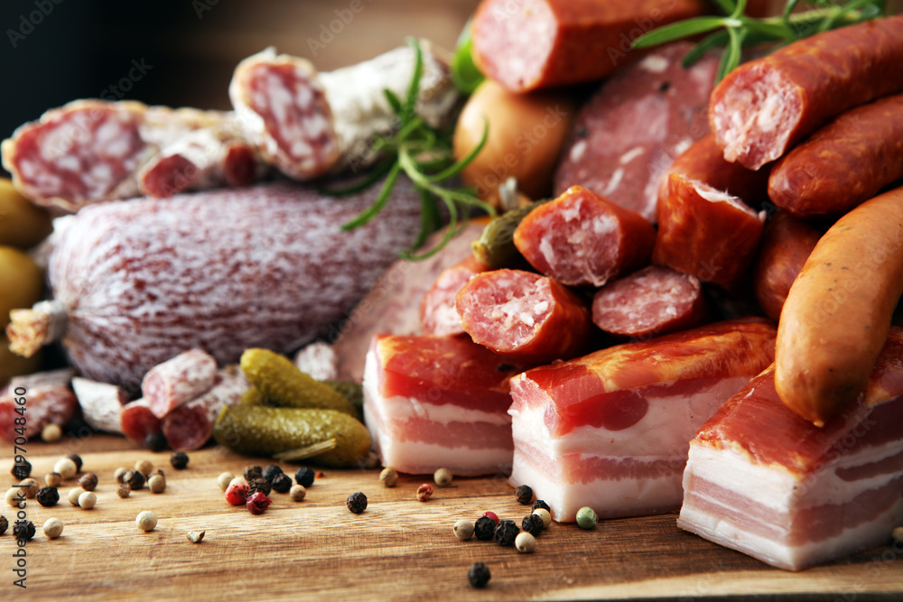 Food tray with delicious salami, ham, fresh sausages, cucumber and herbs. Meat platter with selection Food tray with delicious salami, ham, fresh sausages, cucumber and herbs. Meat platter with selection