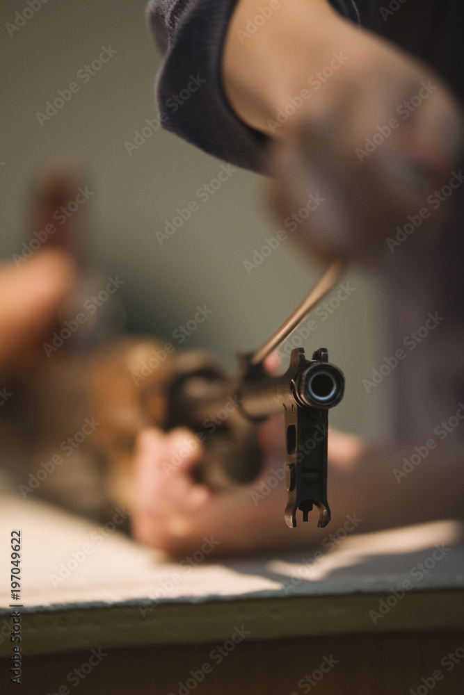 Man assemble military russian weapon on the table Man assemble military russian weapon on the table