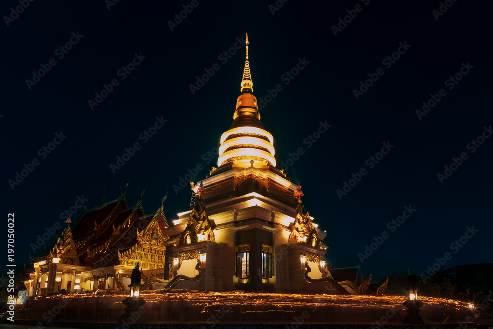 Fototapeta premium People walk with lighted candles to respect Buddha at thailand
