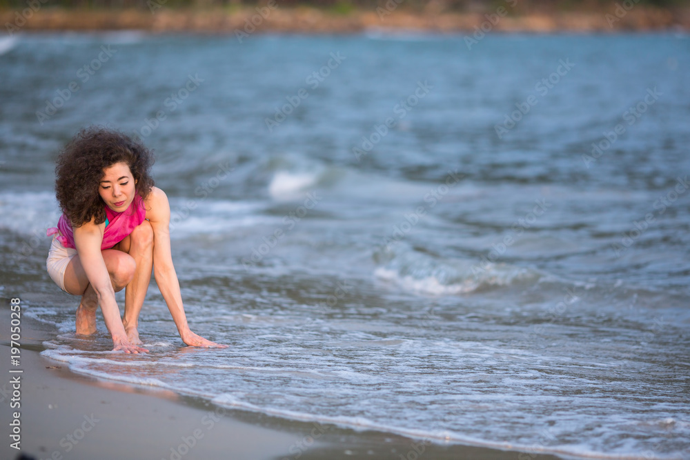 Fototapeta premium Young mixed race woman on the sea beach.