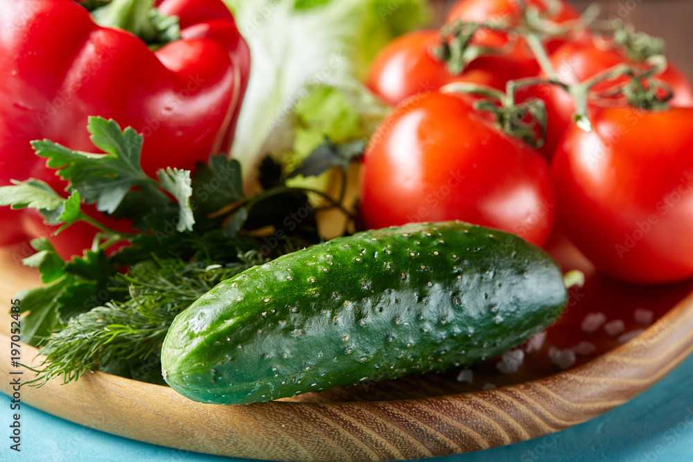 Refreshing close-up still life of assorted fresh vegetables and herbs on blue background, top view, selective focus. Refreshing close-up still life of assorted fresh vegetables and herbs on blue background, top view, selective focus.