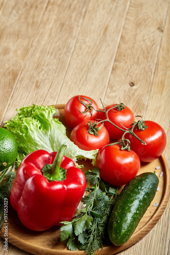 Close-up still life of assorted fresh vegetables and herbs on vintage wooden background  top view  selective focus.