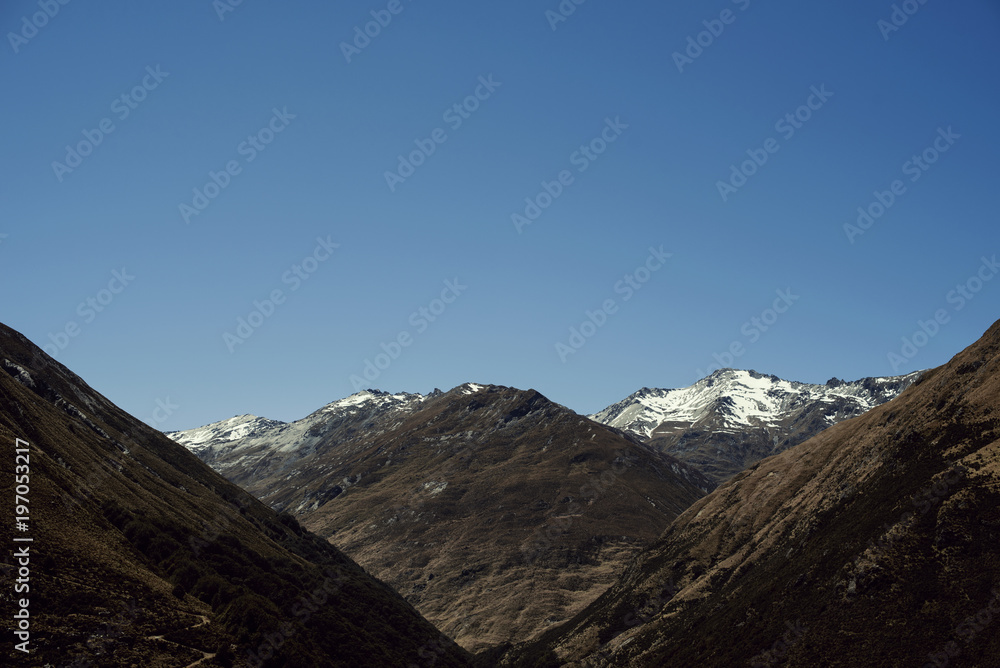 Paisaje de picos de montañas nevadas con cielo azul despejado en Nueva Zelanda