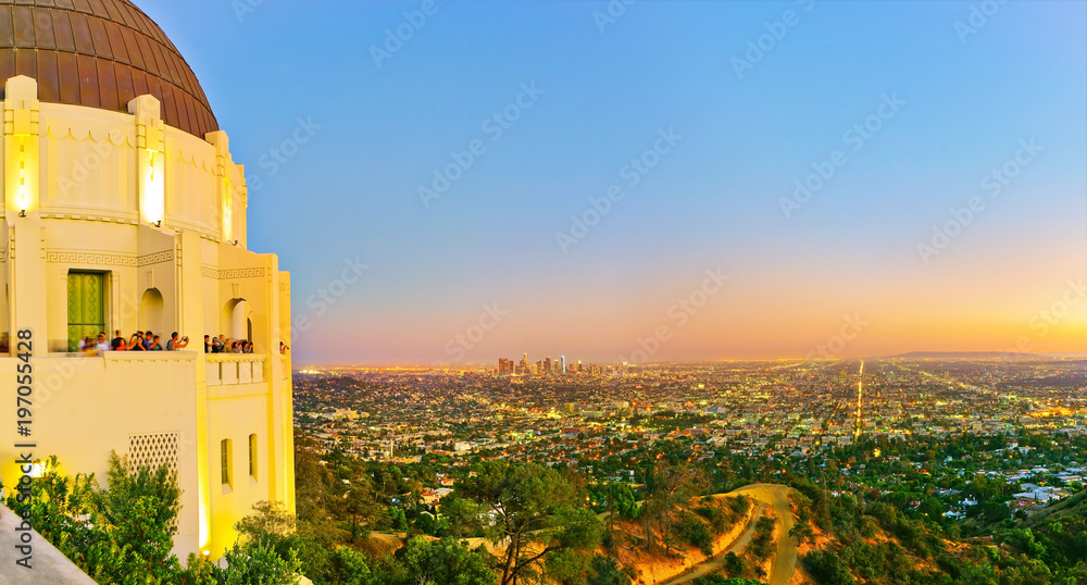 Naklejka premium Widok na Obserwatorium Griffitha i centrum Los Angeles o zachodzie słońca.