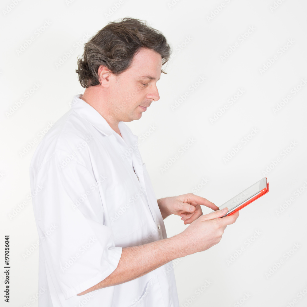 Male doctor using digital tablet in clinic on white background Male doctor using digital tablet in clinic on white background