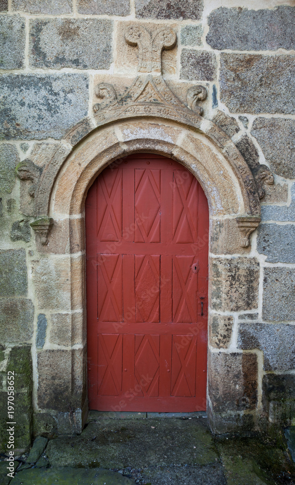 Old red doors and scultpure above.