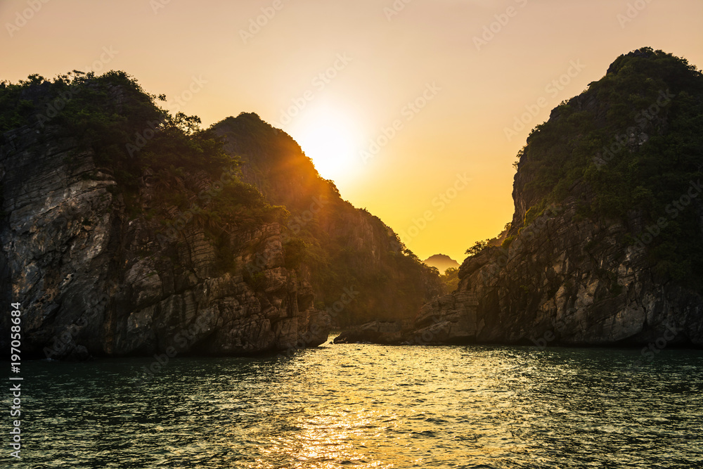 Romantic Halong bay sunset over limestone rocks, Vietnam