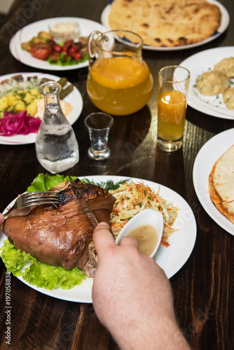 Man eats tasty dish of pork...