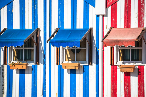 Colorful striped fishermen's houses in blue and red, Costa Nova, Aveiro, Portugal