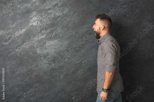 Man expressing anger, feeling furious, shouting photo