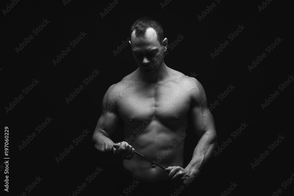 Strong athletic man showes naked muscular body Strong athletic man showes naked muscular body