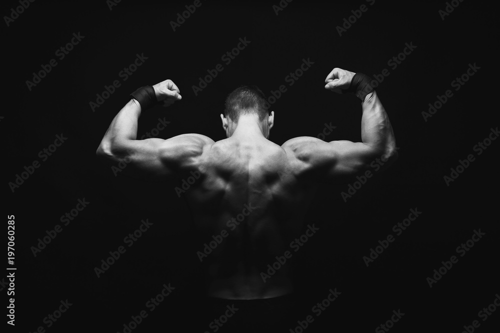 Fototapeta premium Unrecognizable man shows strong back muscles closeup