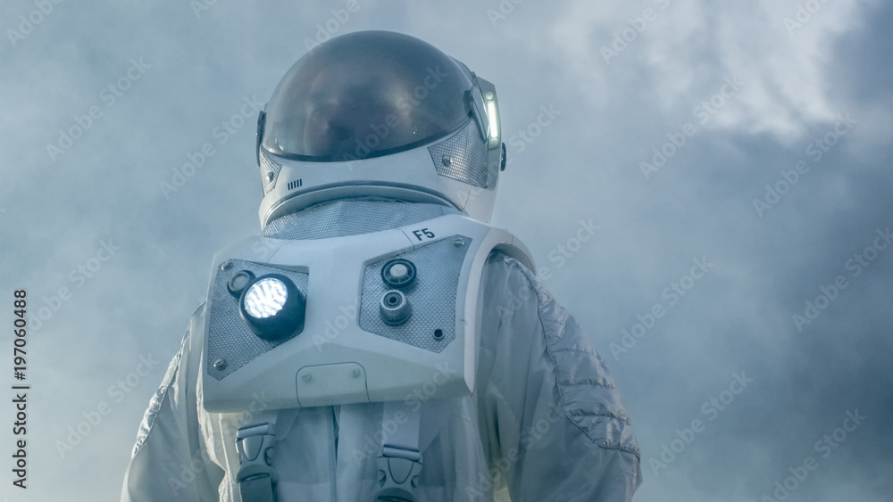 Shot of the Brave Astronaut in the Space Suit Looking Around Alien Planet. Blue and Cold Planet. Advanced Technologies, Space Travel, Colonization Concept.