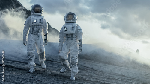 Two Astronauts Explore Rocky Alien Planet in the Day Time. Near Future and Technological Advance Brings Space Exploration, Travel, Colonization Concept.