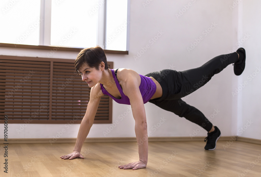 a woman at the gym doing exercises a woman at the gym doing exercises