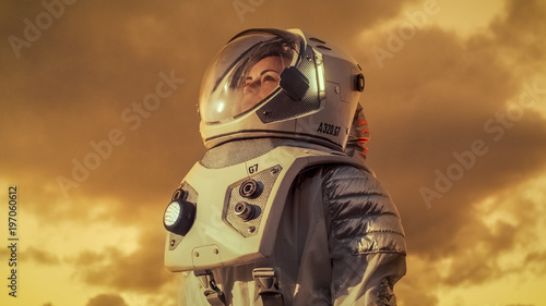 Shot of Female Astronaut in the Space Suit Looking Around Alien Planet. Red and Orange Planet Similar to Mars. Advanced Technologies, Space Travel, Colonization Concept.