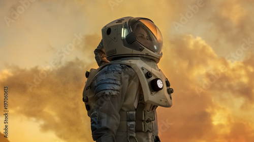 Shot of Female Astronaut in the Space Suit Looking Around Alien Planet. Red and Orange Planet Similar to Mars. Advanced Technologies, Space Travel, Colonization Concept.