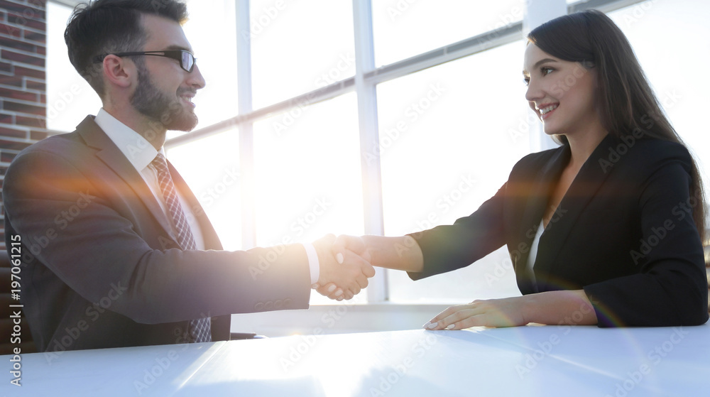 Friendly smiling business people handshaking after pleasant tal Friendly smiling business people handshaking after pleasant tal