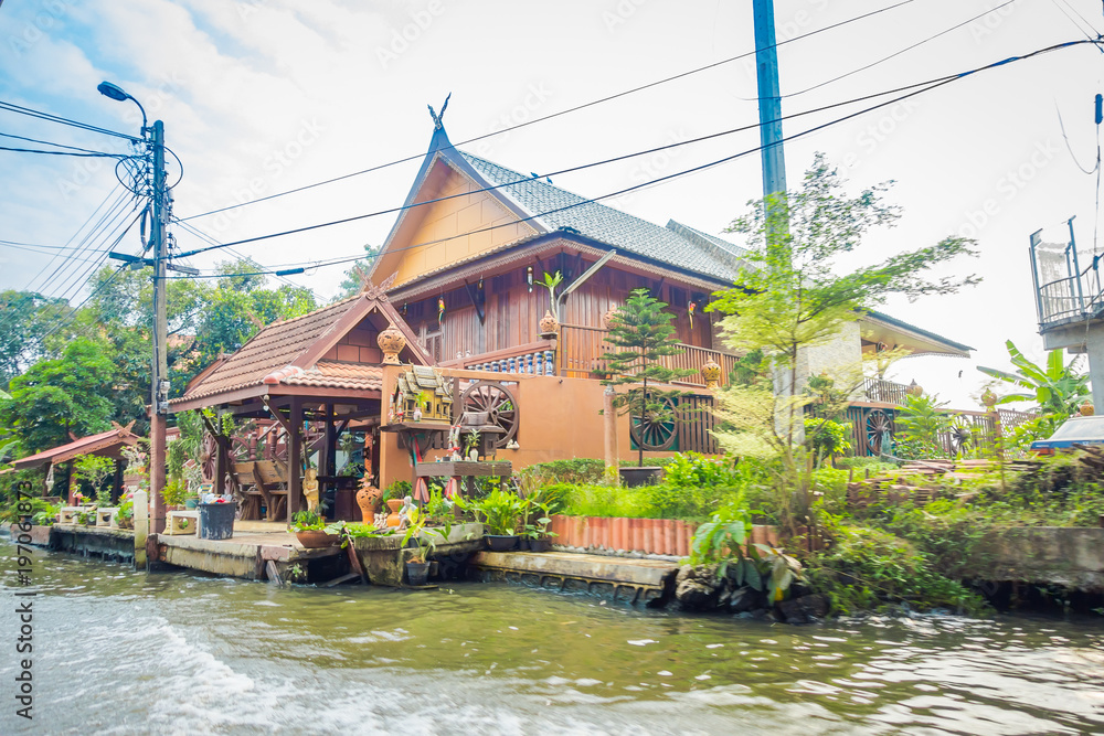 Outdoor view of gorgeous floating wooden house on the Chao Phraya river. Thailand, Bangkok