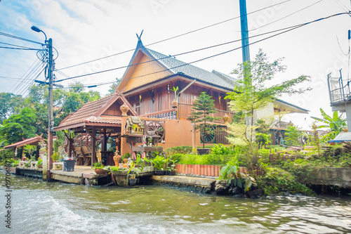 Outdoor view of gorgeous floating wooden house on the Chao Phraya river. Thailand, Bangkok photo