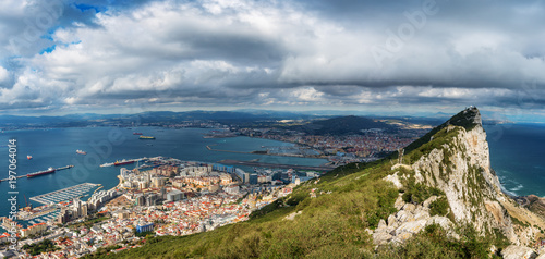 Aerial view on city of Gibraltar from Upper Rock Natural Reserve: on the left Gibraltar town and bay, La Linea town in Spain and Mediterranean Sea on the right. British overseas territory.
