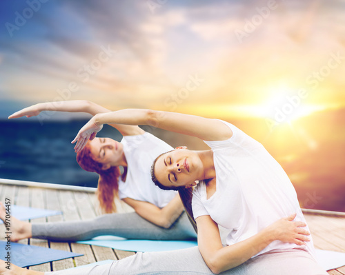 women doing yoga exercises outdoors