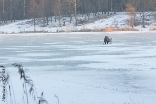 Fisherman on ice. Winter sport ice fishing. Winter fishing. 