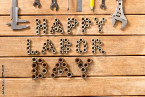 Labor day. Different tools on a wooden table