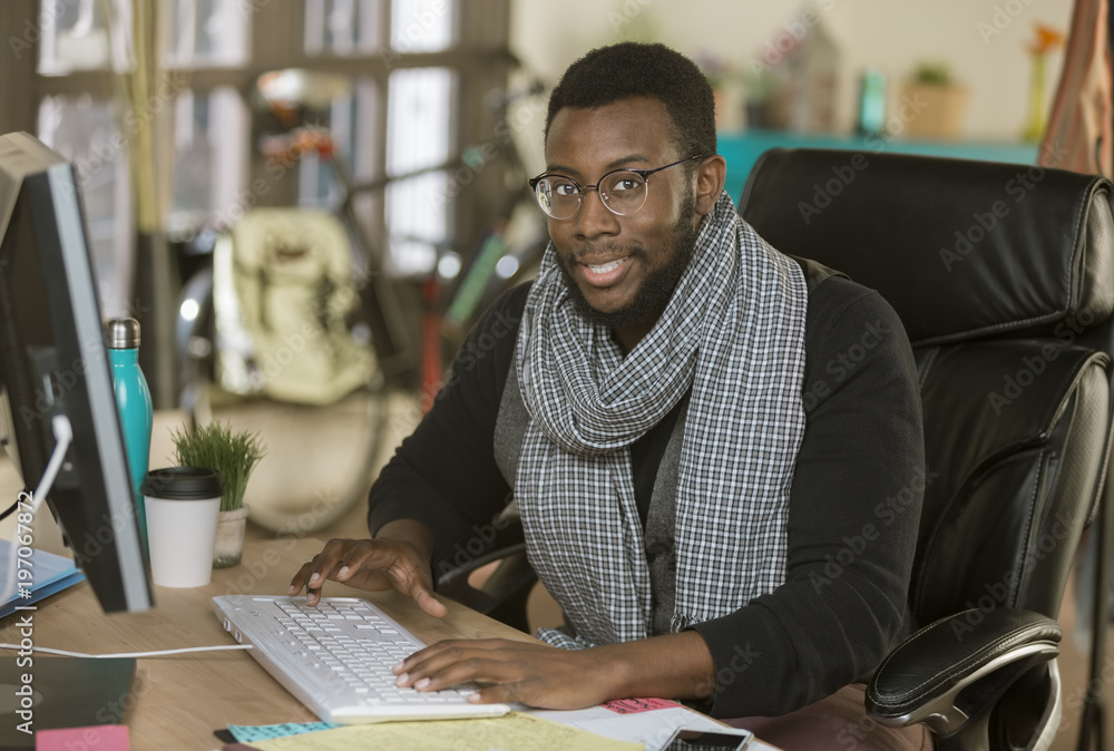Fototapeta premium Handsome Creative Business Man in an Office at Keyboard