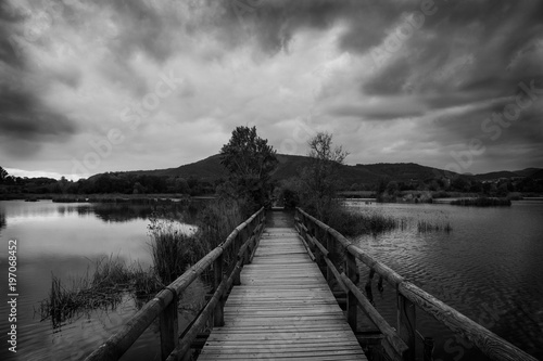 a wood bridge on a lake © ulisse