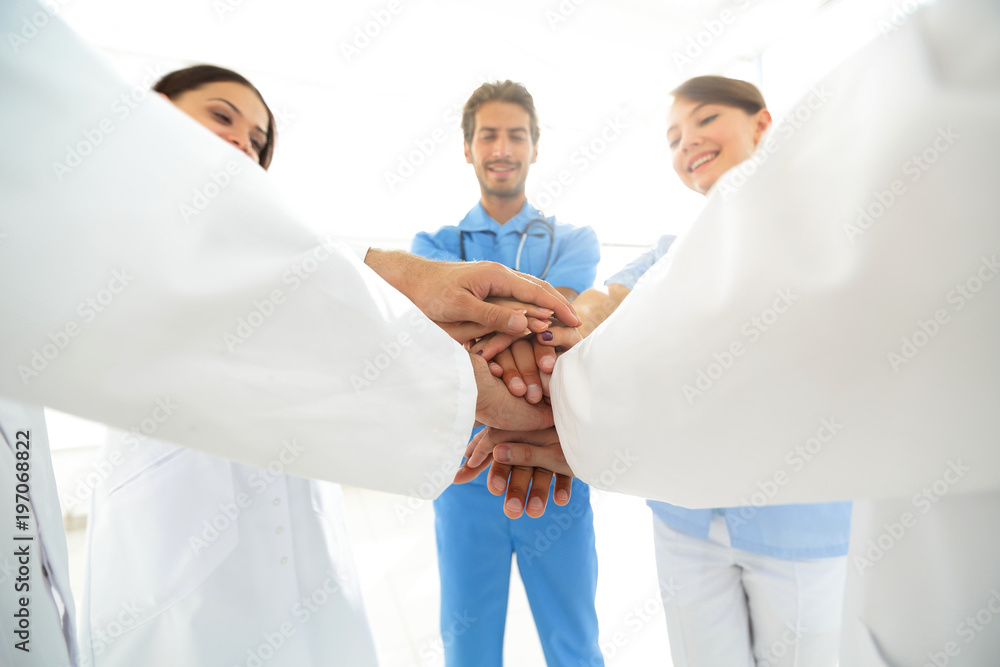 Doctors and nurses in a medical team stacking hands Doctors and nurses in a medical team stacking hands