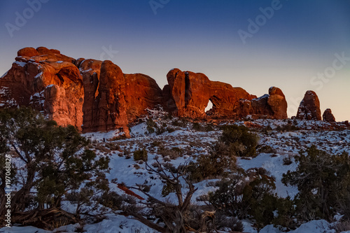 Pristine winter sunset view of Skyline Arch with snow in Arches National Park in Moab, Utah 
