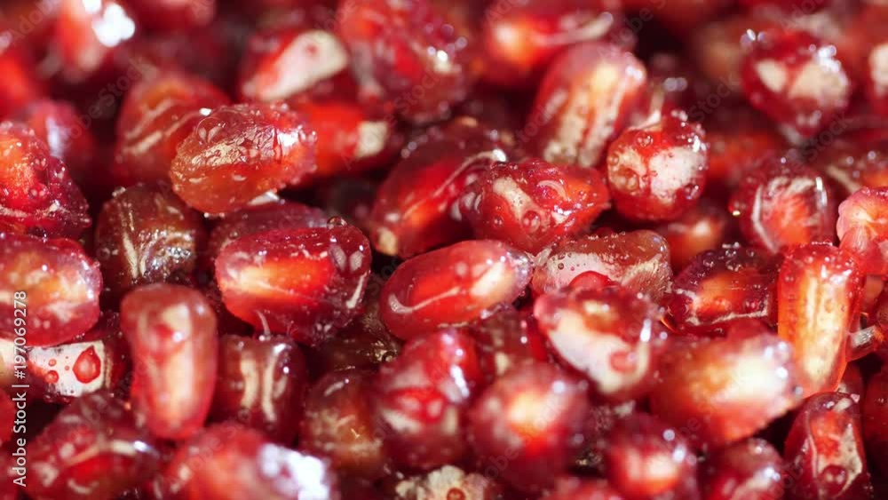 Bright juicy pomegranate. Pomegranate grains on a white background. Macro. macro shooting. juicy. Red grains of pomegranate close up. Beautiful fresh pomegranate. Seeds of pomegranate turn in a shot Bright juicy pomegranate. Pomegranate grains on a white background. Macro. macro shooting. juicy. Red grains of pomegranate close up. Beautiful fresh pomegranate. Seeds of pomegranate turn in a shot