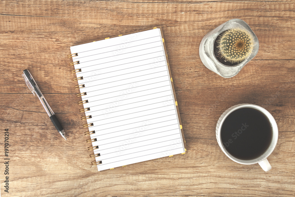 Top view on a wooden desk with open notebook, coffee cup and cactus Top view on a wooden desk with open notebook, coffee cup and cactus