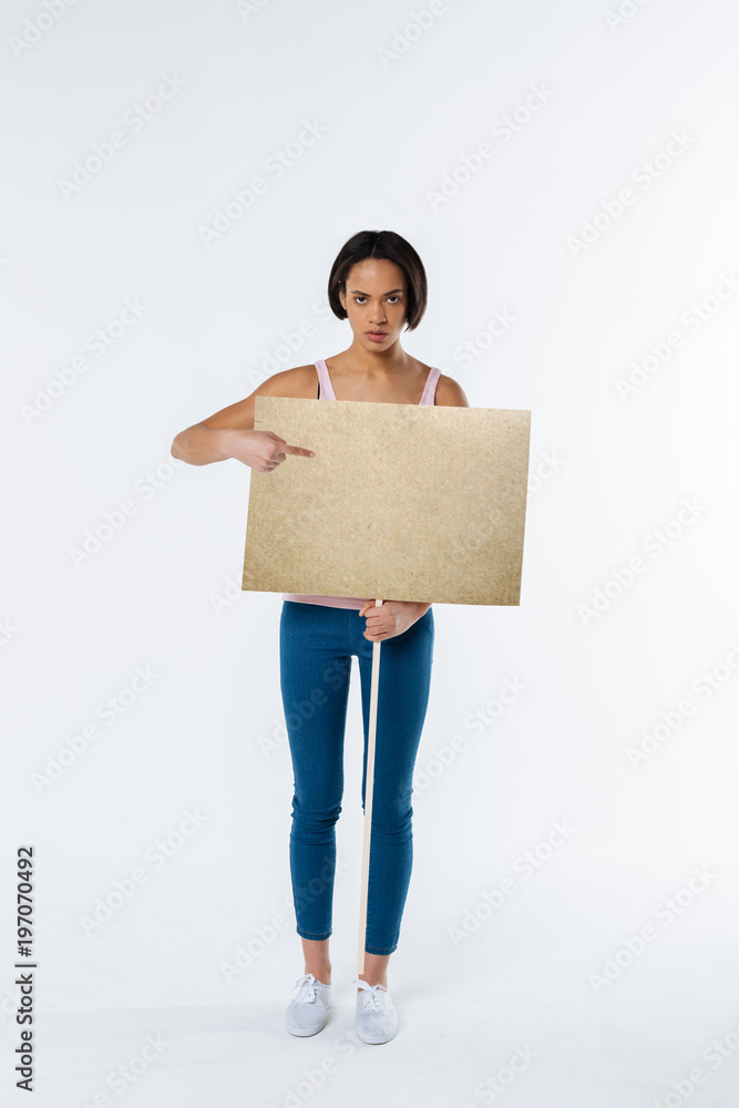 Democracy and liberty. Cheerless nice young woman standing and holding a protest sign while fighting for democracy and liberty Democracy and liberty. Cheerless nice young woman standing and holding a protest sign while fighting for democracy and liberty