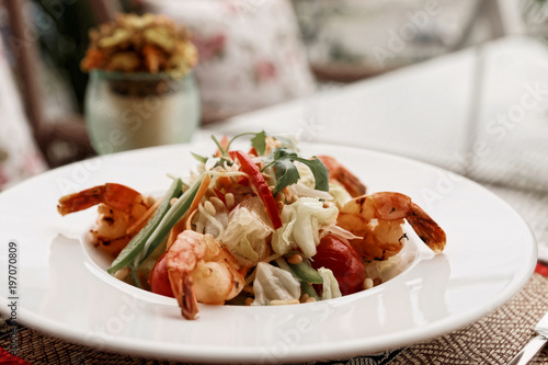 Shrimp starter, light summer dish on table oudoors, toned