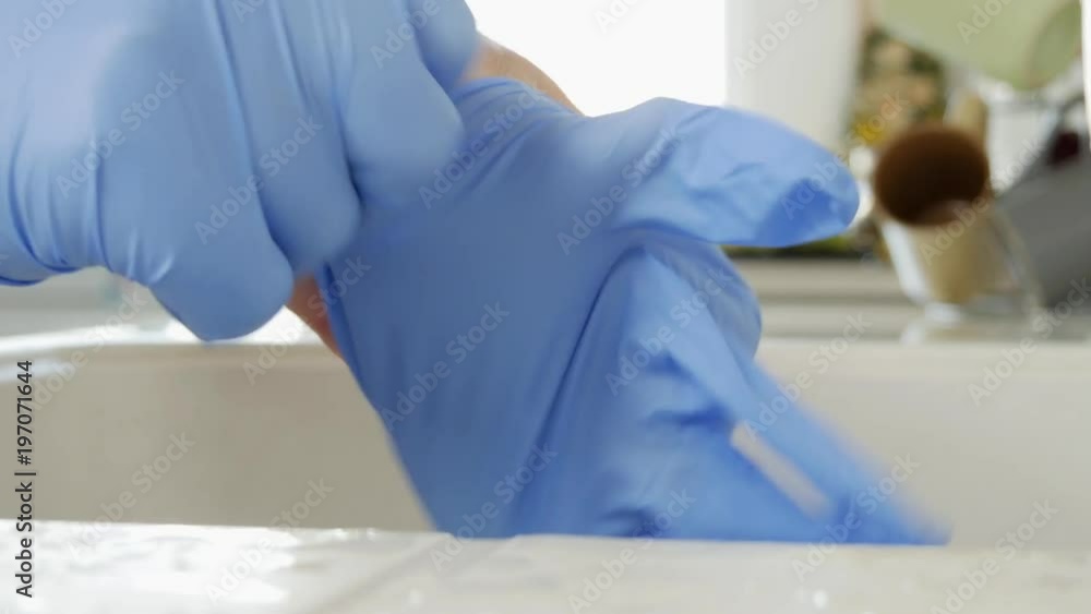Close Up Man Hands in Kitchen Putting Protection Gloves Close Up Man Hands in Kitchen Putting Protection Gloves