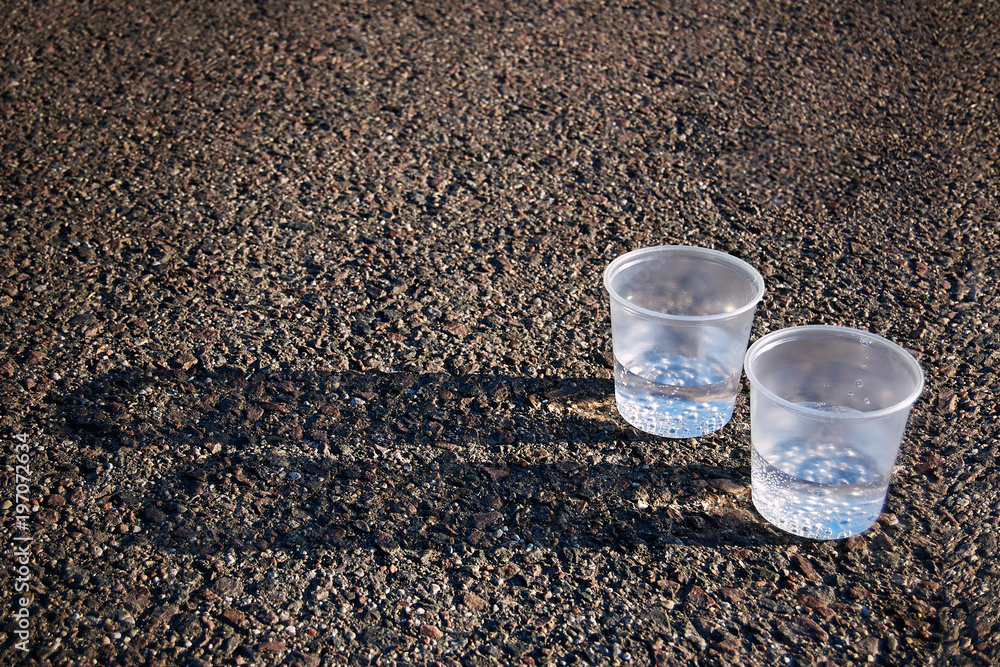 Two plastic cups with pure water and bubbles. Two cups of pure water - concept of nutrition and diet.
