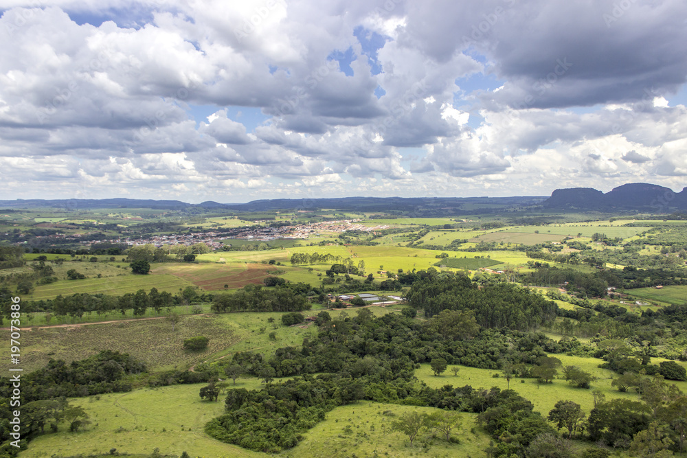 Beautiful mountainous landscape in the interior of Brazil. Some farms, a small town and some plantations are visible