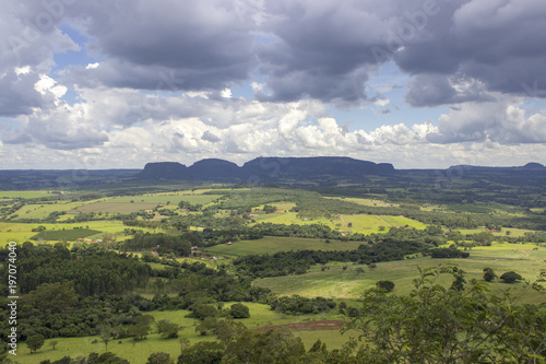 Beautiful mountainous landscape in the interior of Brazil. Some farms, a small town and some plantations are visible