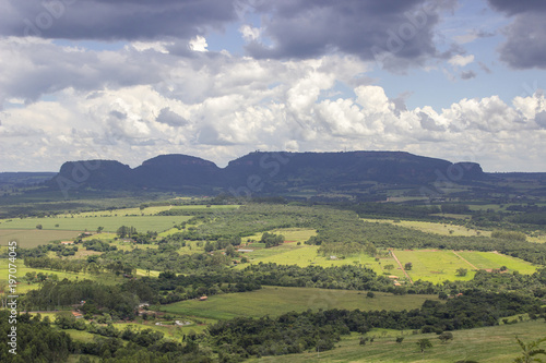 Beautiful mountainous landscape in the interior of Brazil. Some farms, a small town and some plantations are visible