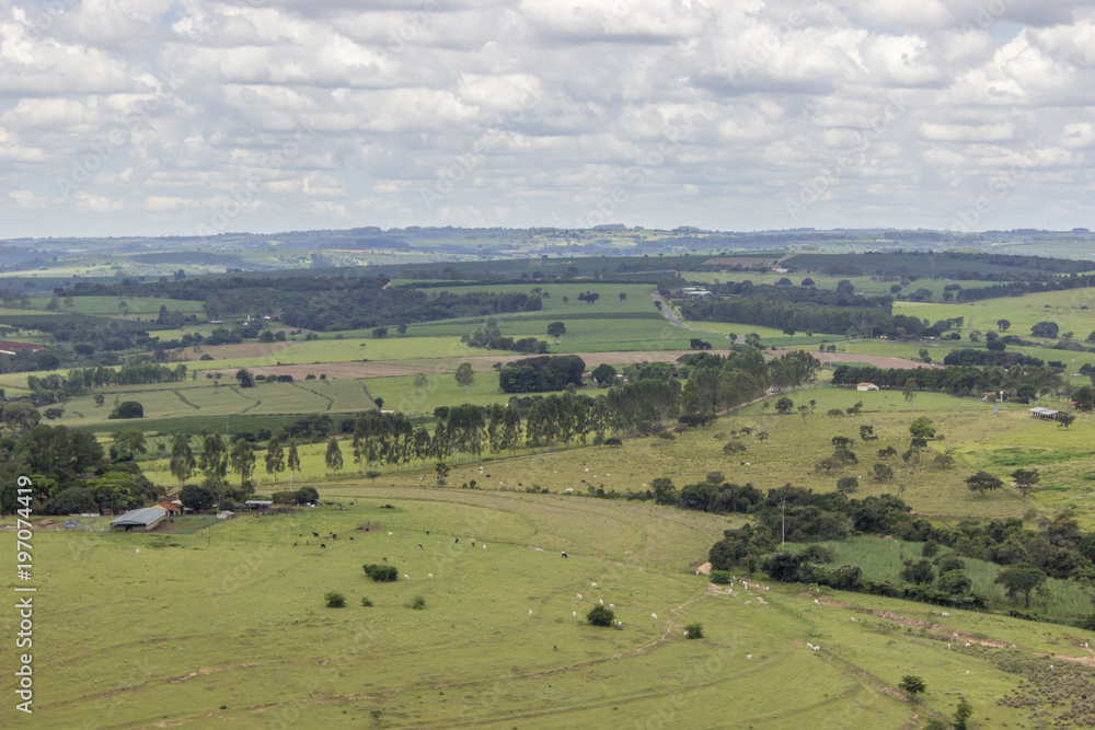 Beautiful mountainous landscape in the interior of Brazil. Some farms, a small town and some plantations are visible Beautiful mountainous landscape in the interior of Brazil. Some farms, a small town and some plantations are visible